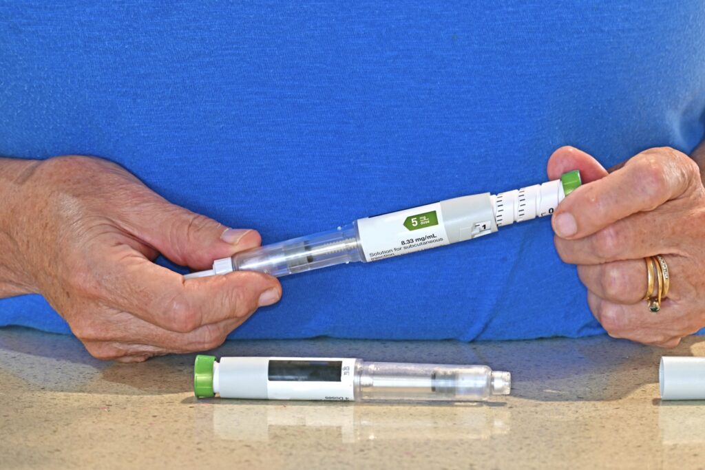 Woman prepares Tirzepatide for weight loss