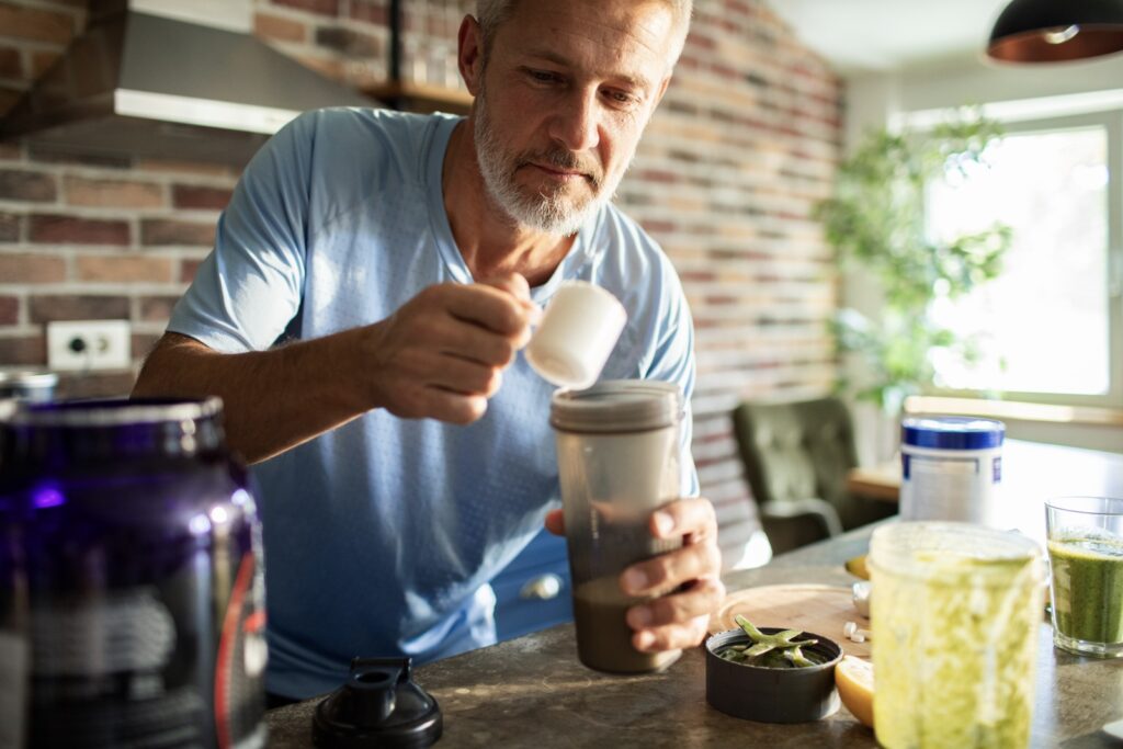 Man prepares meal replacement product to help maintain weight loss after GLP-1s